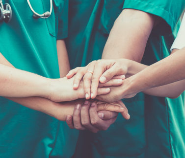 Group,Of,Doctors,And,Nurses,Coordinate,Hands,For,Trust.,Concept